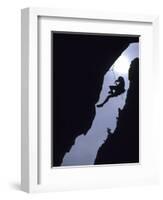 Silhouette of Rock Climber Hanging from Cliff Face-null-Framed Photographic Print