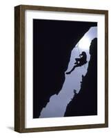 Silhouette of Rock Climber Hanging from Cliff Face-null-Framed Photographic Print