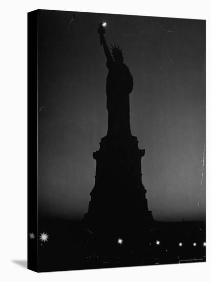 Silhouette of Statue of Liberty Lit by Two 200 Watt Lamps During Wartime Effort to Conserve Energy-Andreas Feininger-Stretched Canvas