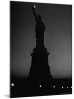 Silhouette of Statue of Liberty Lit by Two 200 Watt Lamps During Wartime Effort to Conserve Energy-Andreas Feininger-Mounted Photographic Print