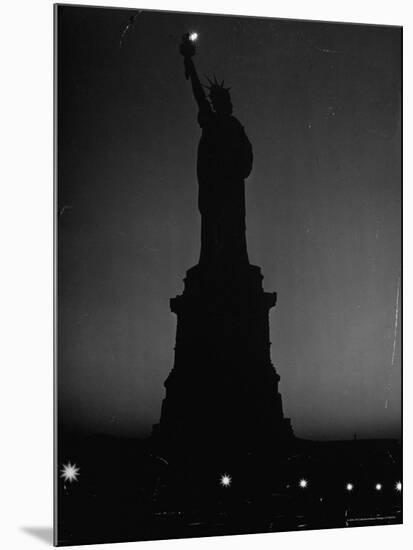 Silhouette of Statue of Liberty Lit by Two 200 Watt Lamps During Wartime Effort to Conserve Energy-Andreas Feininger-Mounted Photographic Print