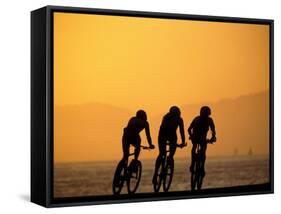 Silhouette of Three Men Riding on the Beach-Mitch Diamond-Framed Stretched Canvas