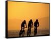 Silhouette of Three Men Riding on the Beach-Mitch Diamond-Framed Stretched Canvas