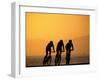 Silhouette of Three Men Riding on the Beach-Mitch Diamond-Framed Premium Photographic Print