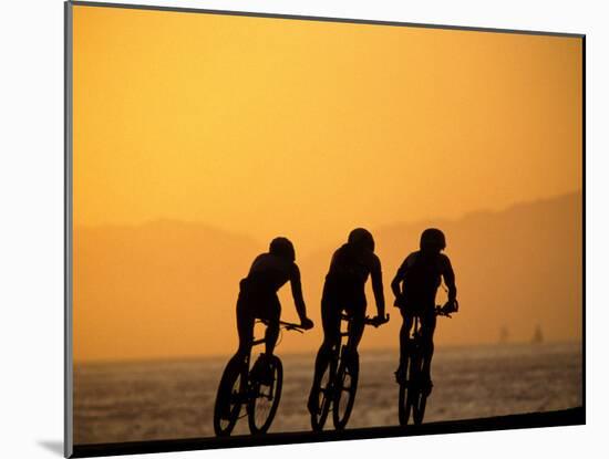 Silhouette of Three Men Riding on the Beach-Mitch Diamond-Mounted Photographic Print