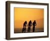 Silhouette of Three Men Riding on the Beach-Mitch Diamond-Framed Photographic Print