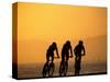 Silhouette of Three Men Riding on the Beach-Mitch Diamond-Stretched Canvas