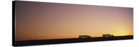 Silhouette of Two Trucks Moving on a Highway, Interstate 5, California, USA-null-Stretched Canvas