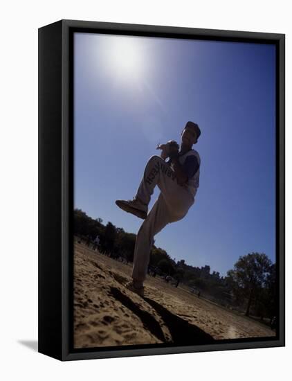 Silhouette of Young Boy in Action Pitching-null-Framed Stretched Canvas