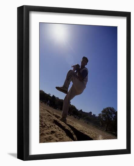 Silhouette of Young Boy in Action Pitching-null-Framed Photographic Print