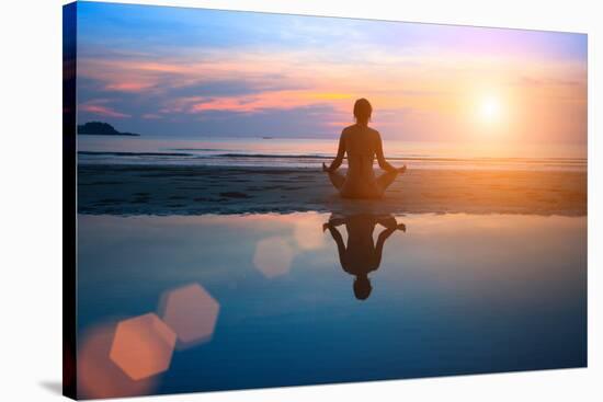 Silhouette Young Woman Practicing Yoga on the Beach at Sunset-De Visu-Stretched Canvas