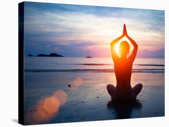 Silhouette Young Woman Practicing Yoga on the Beach at Sunset.-De Visu-Stretched Canvas