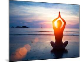 Silhouette Young Woman Practicing Yoga on the Beach at Sunset.-De Visu-Mounted Photographic Print