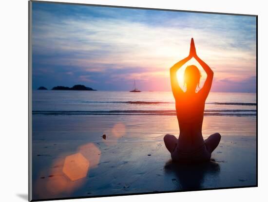 Silhouette Young Woman Practicing Yoga on the Beach at Sunset.-De Visu-Mounted Photographic Print