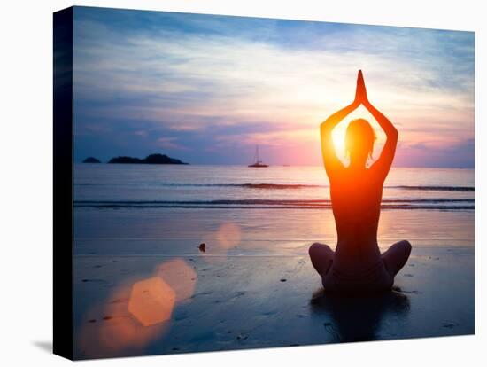 Silhouette Young Woman Practicing Yoga on the Beach at Sunset.-De Visu-Stretched Canvas