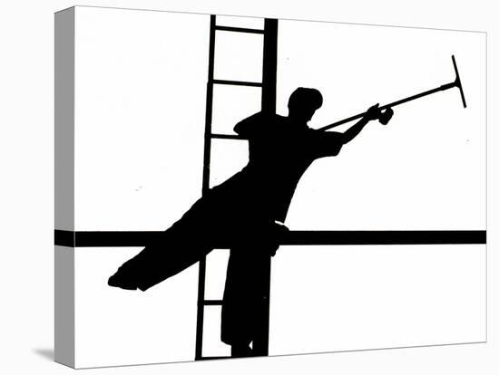 Silhouetted against the Bright Morning Sun, a Window Cleaner Stretches to Clean a Spot-null-Stretched Canvas