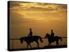 Silhouetted Men Riding on Horses, Dubai, UAE-Henry Horenstein-Stretched Canvas