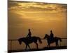 Silhouetted Men Riding on Horses, Dubai, UAE-Henry Horenstein-Mounted Photographic Print