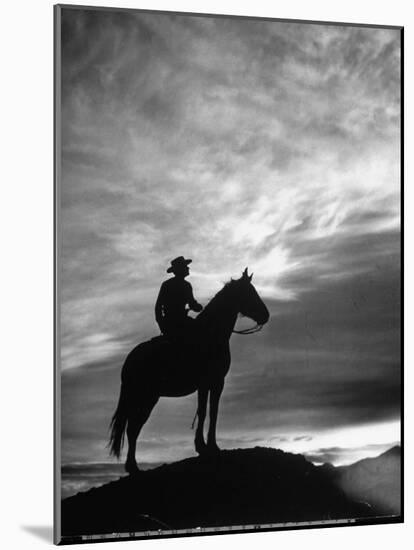 Silhouettes of Cowboy Mounted on Horse-Allan Grant-Mounted Photographic Print