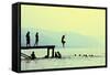 Silhouettes of Kids Who Jump off Dock on the Lake at Sunset.-Mita Stock Images-Framed Stretched Canvas