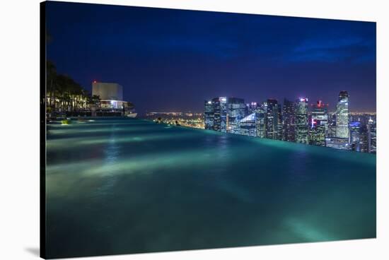 Singapore, Rooftop Swimming Pool at Dusk Overlooks the City-Walter Bibikow-Stretched Canvas