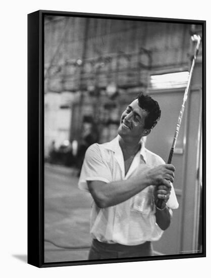 Singer and Actor Dean Martin holding a pitching club on Movie Set for MGM's "Some Came Running"-Allan Grant-Framed Stretched Canvas