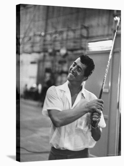 Singer and Actor Dean Martin holding a pitching club on Movie Set for MGM's "Some Came Running"-Allan Grant-Stretched Canvas