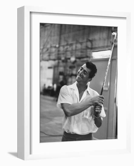 Singer and Actor Dean Martin holding a pitching club on Movie Set for MGM's "Some Came Running"-Allan Grant-Framed Premium Photographic Print