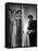 Singer Julie Wilson on Phone Beside Closet with Hanging Evening Dresses and Wigs on Top Shelf-Nina Leen-Framed Stretched Canvas