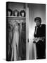 Singer Julie Wilson on Phone Beside Closet with Hanging Evening Dresses and Wigs on Top Shelf-Nina Leen-Stretched Canvas