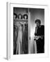 Singer Julie Wilson on Phone Beside Closet with Hanging Evening Dresses and Wigs on Top Shelf-Nina Leen-Framed Premium Photographic Print