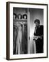 Singer Julie Wilson on Phone Beside Closet with Hanging Evening Dresses and Wigs on Top Shelf-Nina Leen-Framed Premium Photographic Print