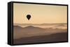 Single Hot Air Balloon over a Misty Dawn Sky, Cappadocia, Anatolia, Turkey, Asia Minor, Eurasia-David Clapp-Framed Stretched Canvas