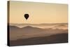 Single Hot Air Balloon over a Misty Dawn Sky, Cappadocia, Anatolia, Turkey, Asia Minor, Eurasia-David Clapp-Stretched Canvas