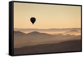 Single Hot Air Balloon over a Misty Dawn Sky, Cappadocia, Anatolia, Turkey, Asia Minor, Eurasia-David Clapp-Framed Stretched Canvas