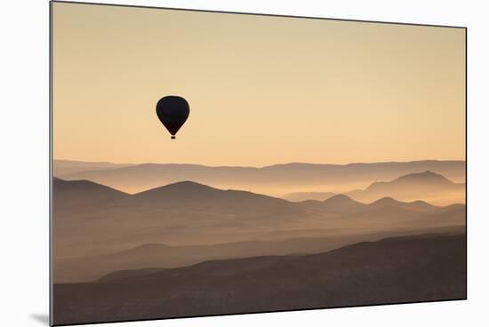 Single Hot Air Balloon over a Misty Dawn Sky, Cappadocia, Anatolia, Turkey, Asia Minor, Eurasia-David Clapp-Mounted Photographic Print