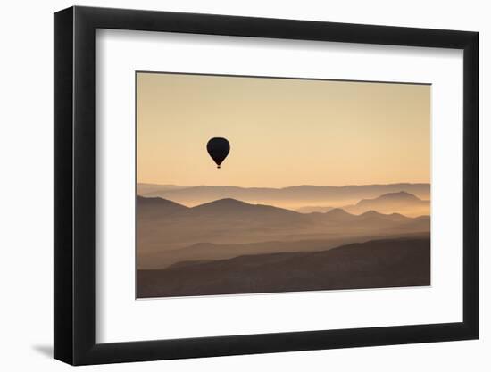 Single Hot Air Balloon over a Misty Dawn Sky, Cappadocia, Anatolia, Turkey, Asia Minor, Eurasia-David Clapp-Framed Photographic Print