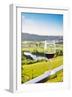 Single wine glass above vineyards, Piedmont, Italy, Europe-Alexandre Rotenberg-Framed Photographic Print