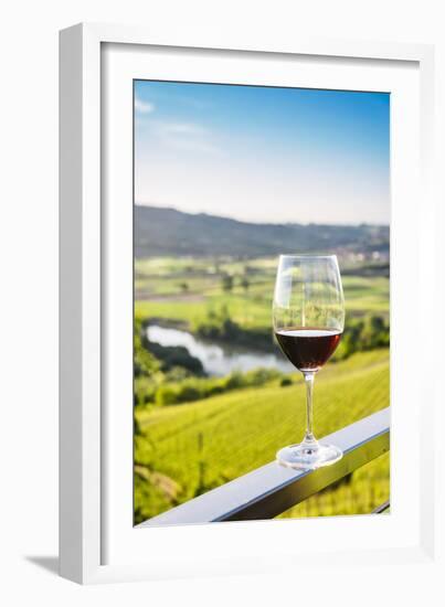 Single wine glass above vineyards, Piedmont, Italy, Europe-Alexandre Rotenberg-Framed Photographic Print