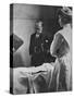 Sir William Osler Reading a Patient's Chart at Bedside as a Nurse Watches, Ca. 1903-null-Stretched Canvas