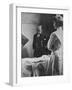 Sir William Osler Reading a Patient's Chart at Bedside as a Nurse Watches, Ca. 1903-null-Framed Photo