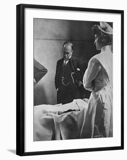 Sir William Osler Reading a Patient's Chart at Bedside as a Nurse Watches, Ca. 1903-null-Framed Photo