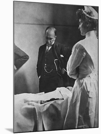 Sir William Osler Reading a Patient's Chart at Bedside as a Nurse Watches, Ca. 1903-null-Mounted Photo