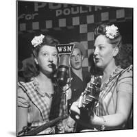 Sisters Performing at the Microphone at the Grand Ole Opry-Ed Clark-Mounted Premium Photographic Print