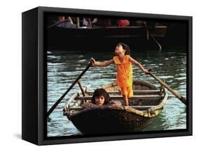 Sisters Who Live with Their Family on Halong Bay, Vietnam, Row Their Boat out to Greet Tourists-null-Framed Stretched Canvas