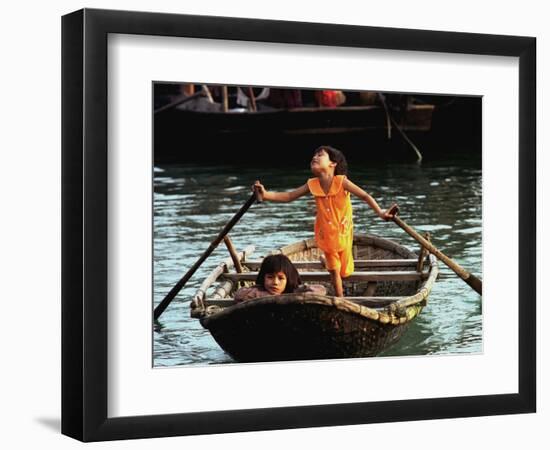 Sisters Who Live with Their Family on Halong Bay, Vietnam, Row Their Boat out to Greet Tourists-null-Framed Photographic Print