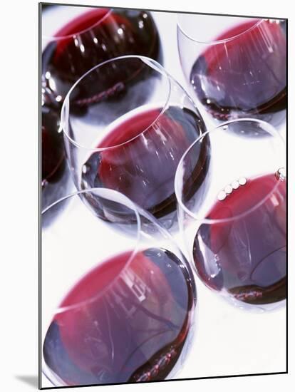 Six Glasses of Red Wine Against White Background-Linda Burgess-Mounted Photographic Print