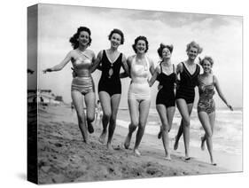 Six Women, in Swimsuits, Run in a Row Along a Beach, 1942-null-Stretched Canvas