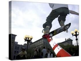 Skateboarder in Midair Knocking Over a Cone-null-Stretched Canvas