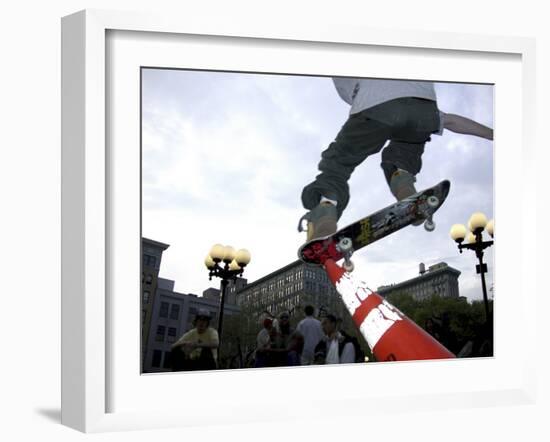 Skateboarder in Midair Knocking Over a Cone-null-Framed Premium Photographic Print